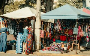 Colorful textile and fashion stalls in a Nairobi market, showcasing diverse African patterns and designs.