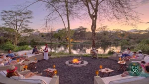 sunset cocktails set up with a bonfire.