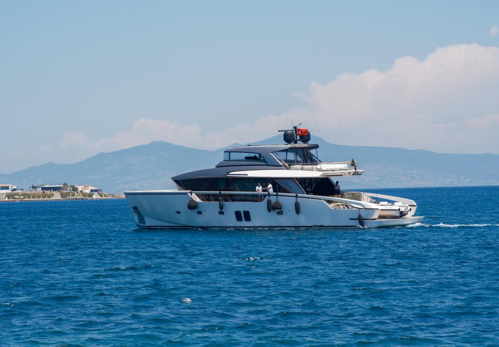 pexels photo 25300829 25300829 A sleek yacht cruising through Foça's clear blue waters under a bright sky in İzmir, Türkiye.