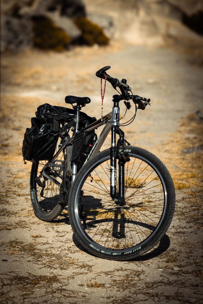 pexels photo 33217877 33217877 Mountain bike with gear on a rocky surface, perfect for adventure enthusiasts.